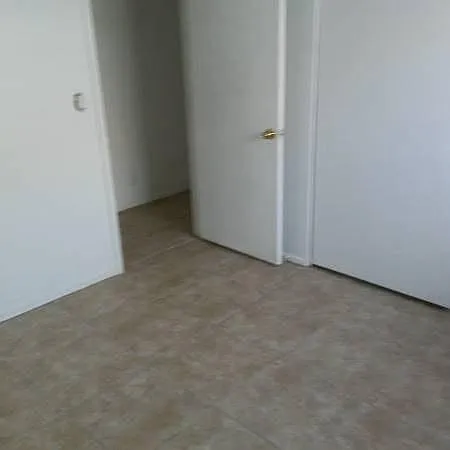 Second bedroom opens to hallway where washer and dryer reside behind a hall closet.