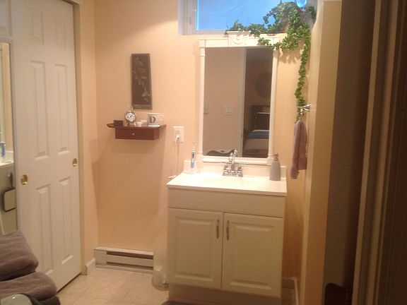 Updated bathroom with natural daylight , vanity, tiled shower.