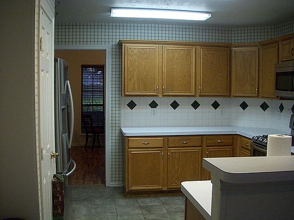 This wonderful kitchen features lots of cabinet space ceramic flooring, built-in stainless microwave