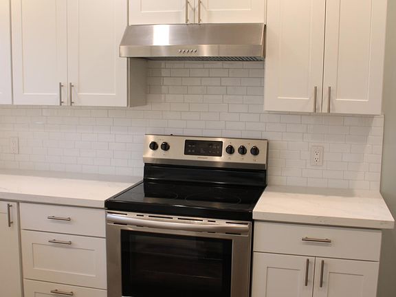 Brand new kitchen with quartz countertops.