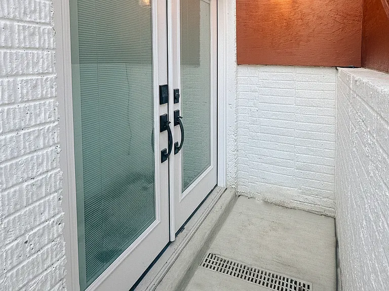 Exterior stairway and private entrance area leading down to the apartment.