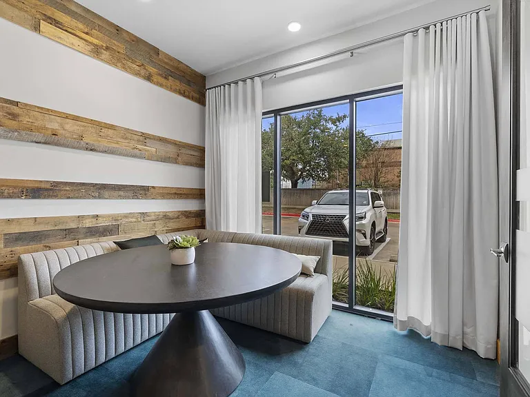 Relax on the corner couch by the window and enjoy the perfect spot for conversation or quiet work.