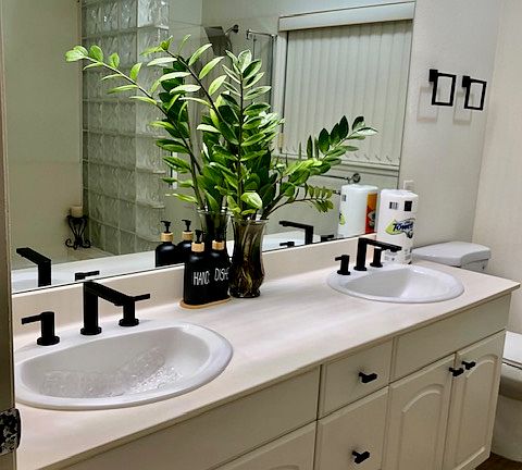 Large bath boasts with new fixtures, double sink, tub, and shower