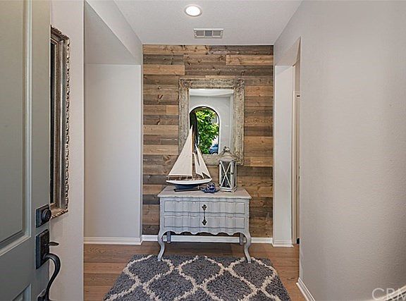 Entry with barn-wood accent wall.