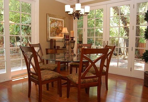 Separate formal dining room with doors to lush backyard.