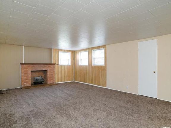 Large living room with decorative fireplace & cold storage closet