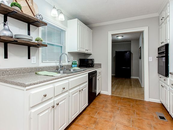 Kitchen with open shelving and lots of storage.