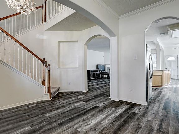 Foyer opens to the formal dining to the right and living area straight ahead.