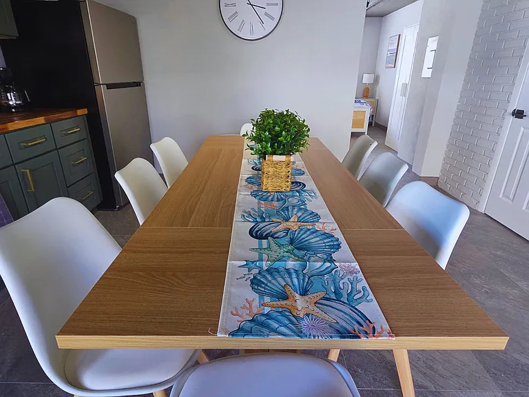 Decorated dining room with elegant centerpiece and runner