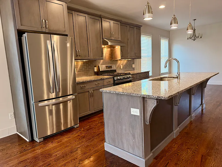 Stainless steel appliances, gas stove with electric oven, granite countertops, and stainless steel tile for the backsplash