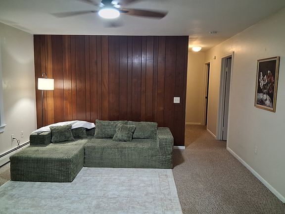 Another view of living room with hallway to bathroom and bedrooms