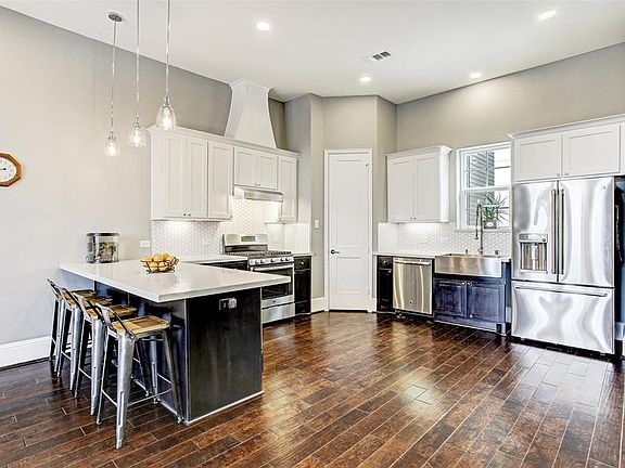 The kitchen has clean modern lines with decorative backsplash, sealed marble counters, custom soft close cabinets, and stainless appliances and farmerâs sink, plus a large pantry.