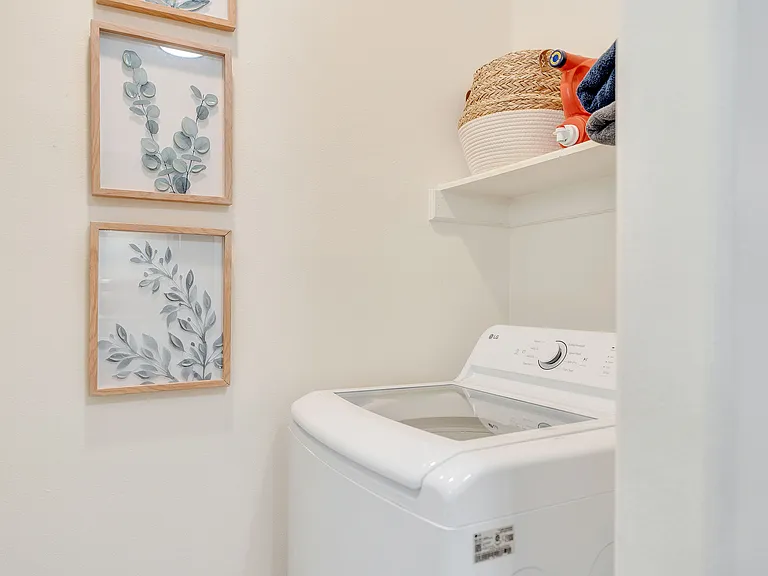 A chic laundry room featuring a modern washer and dryer, located in La Joya Apartments, Laredo, Texas