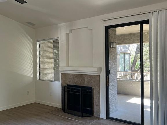Living area with fireplace and balcony