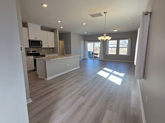 Walk into an open floor plan with a luxury kitchen, dining room, living room combo with all new LVP floors. The curtains are included in the rent!