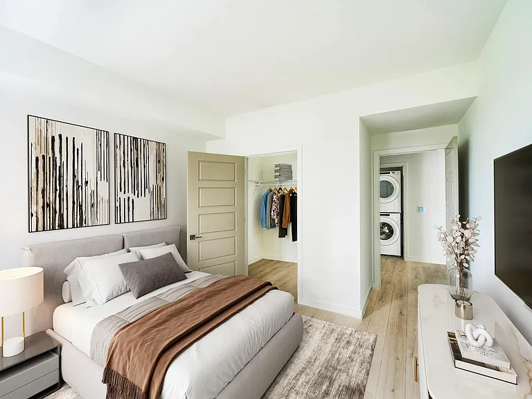 Natural light, neutral tones, and a spacious closet create a bedroom retreat that's as functional as it is inviting at Modera Coral Springs North Tower.