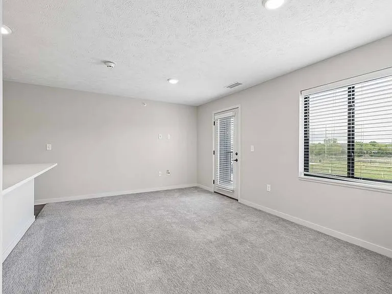 Large windows and an open, airy layout fill the space with natural light, creating a comfortable setting to relax and feel at home
