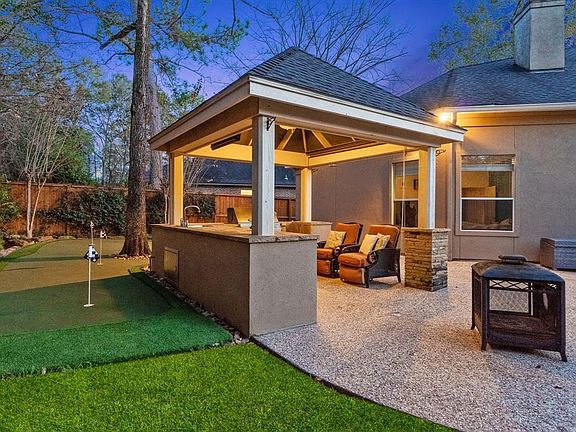 Ready for entertaining green putting, summer kitchen for night entertaining.