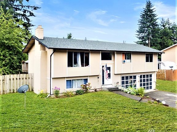 Left front side of home with fireplace chimney's on the end