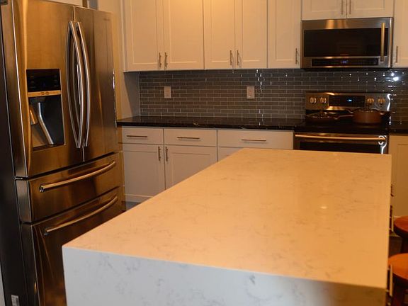 Gourmet Kitchen: Sansung ss applc's. Quartz waterfall counte