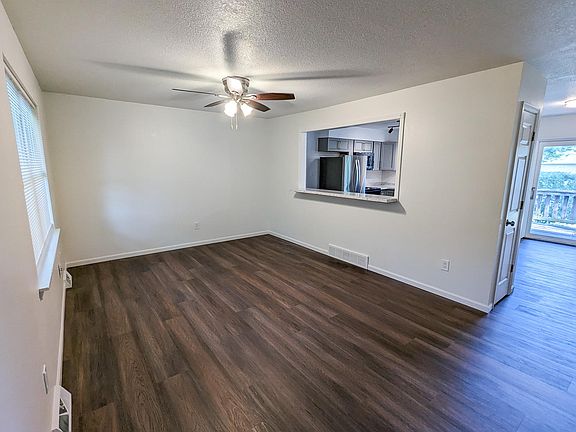 Living room with pass-through to kitchen complete with a breakfast bar