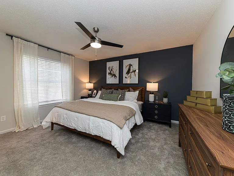 Cozy bedroom with carpet and overhead lighting