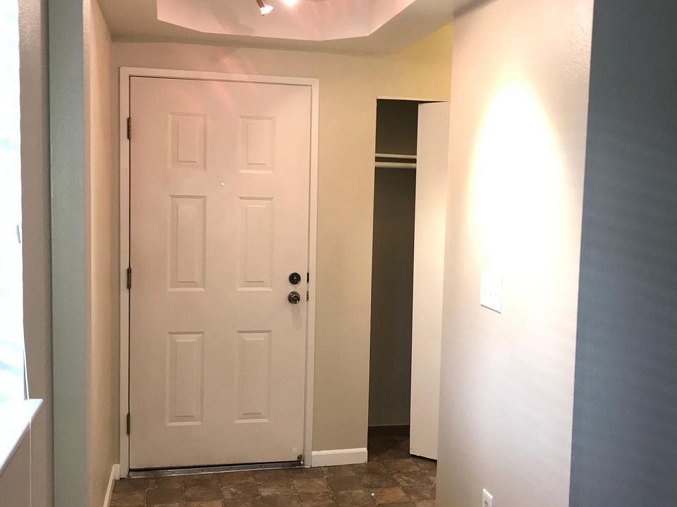 View of front door from living room. Nice foyer! Check out that recessed lighting!