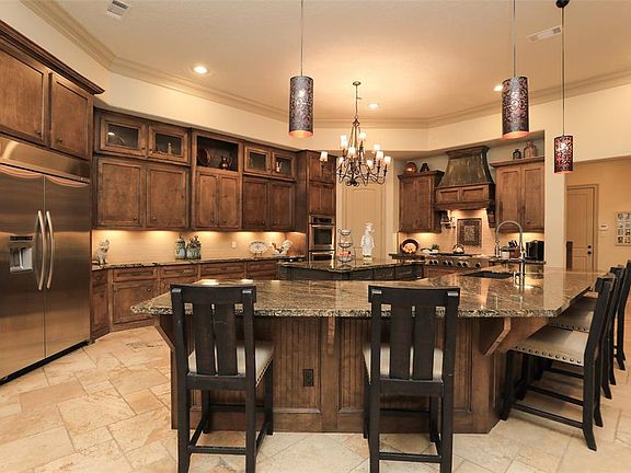 Amazing kitchen that is GREAT for entertaining! Huge island plus massive Breakfast bar! Stainless appliances include built in refrigerator, double ovens, Gas Sove, Pot filler and tons of cabinets! Large walk in pantry!