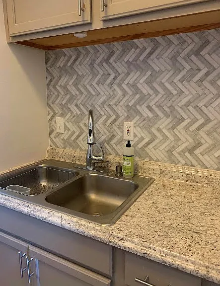 kitchen sink with tile backsplash