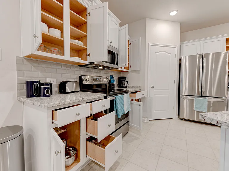 All the kitchen essentials are included _ toaster, pots and pans, knives, coffee maker, blender, plates, utensils, bowls, glasses, and mugs.