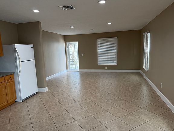 Living room with ample natural light and impact windows