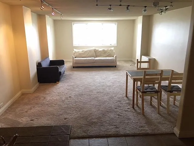 Extremely large living room with windows with a downtown Denver & Mountain view
