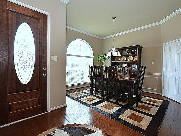WALK INTO THIS AMAZING ENTRY THAT FEATURES THIS LEAD GLASS FRONT DOOR & WOOD FLOORING