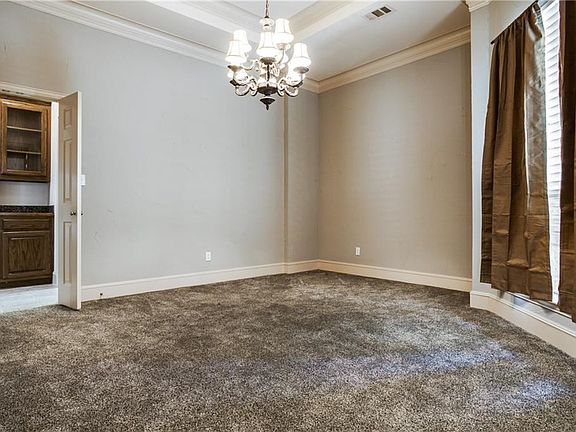 The formal dining room allows for grand scale entertaining and features a butler's panty