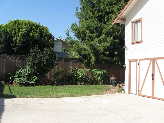Large back yard with brick patio area.