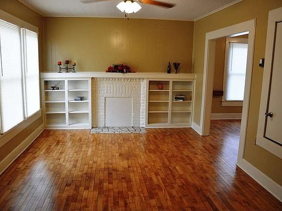 "Gleaming hardwood floors and built-ins accent family room"