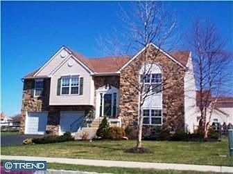 Stone front with attached two garage with fenced in back and side yards.