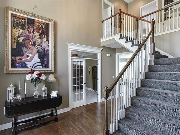 Grand 2 story entry with hardwoods, double staircase, and tons of natural light.