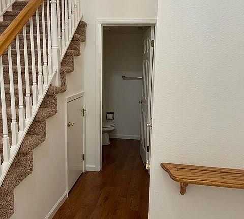 Hall to Half Bath downstairs. Hall to Garage. Storage under stairs.
