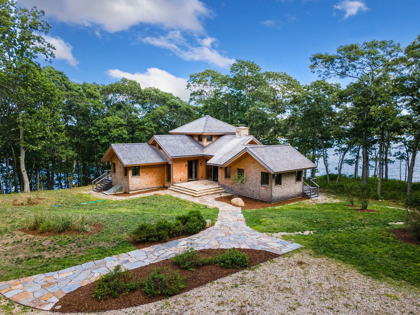  Contemporary style home with wood roof, cedar shingle siding and flagstone walkway