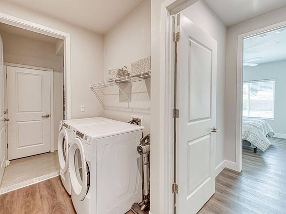 laundry room, washer & dryer included with rack storage and cabinet storage in some units