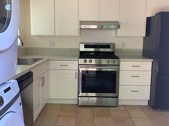 Kitchen with 5 burner gas stove.