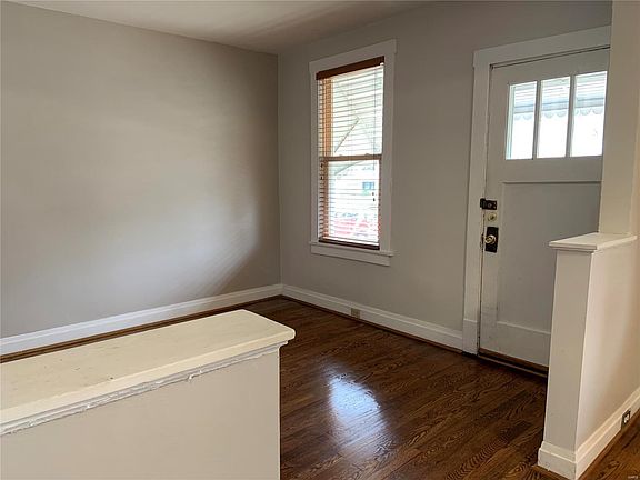 Entry door to living room. Wood floors throughout