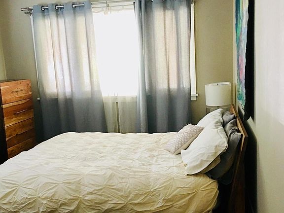 Cozy Bedroom with a laundry chute that drops right into the basement where there is a washer/dryer and laundry area.