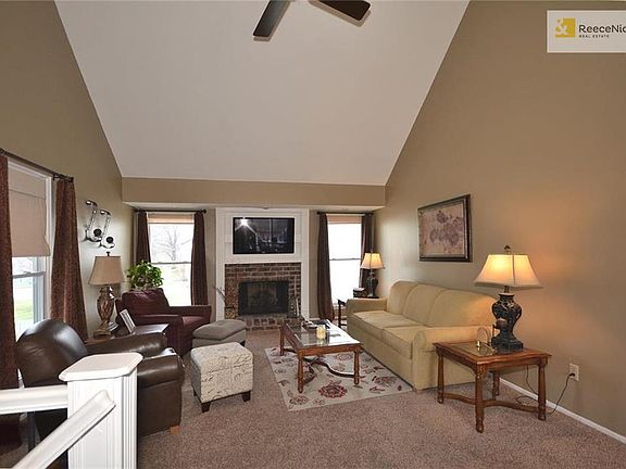 Vaulted living room with ceiling fan