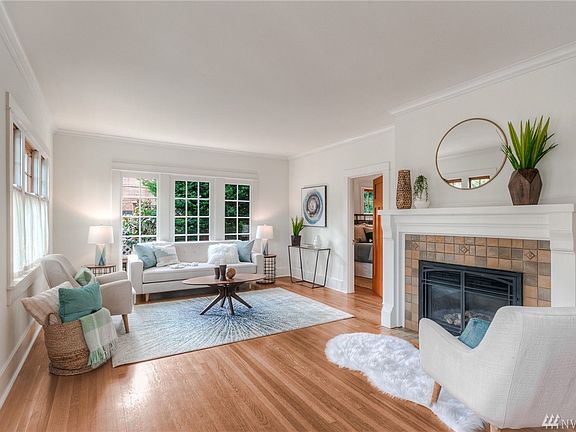 Expansive living space, original word floors throughout, gas fireplace and new gas fired radiant heating throughout the home