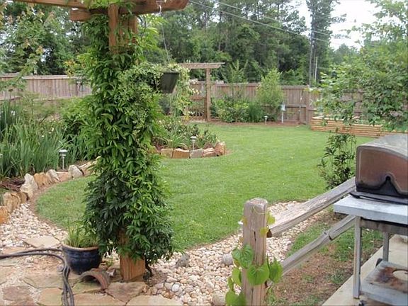 BACK YARD WITH EXTENSIVE LANDSCAPING