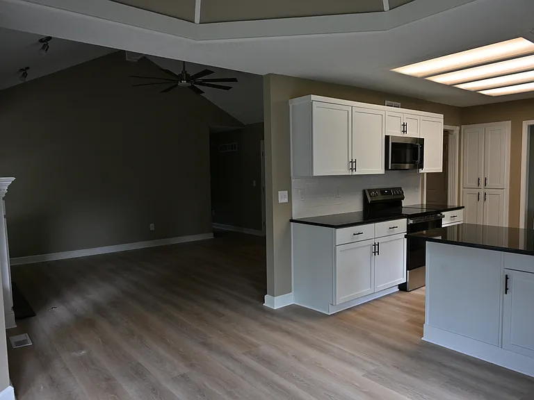 View of living room and kitchen from dining area.