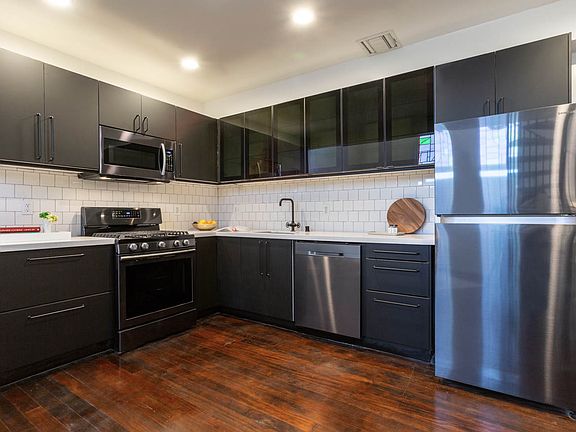 Fully remodeled and upgraded gourmet kitchen with stainless steel appliances and quartz countertop