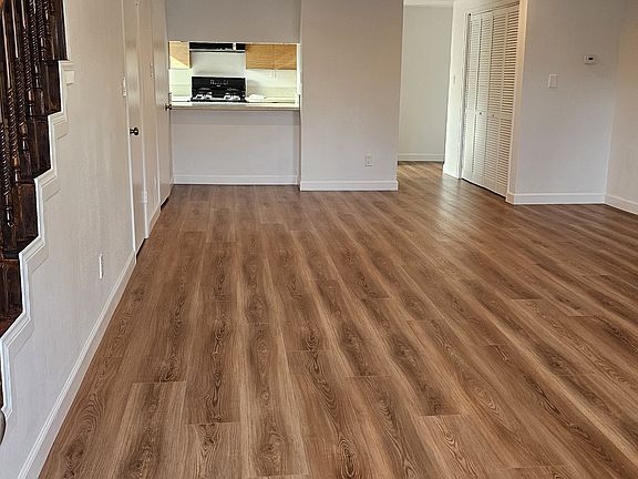 From door entry looking at open floor plan for living and dinning space. Towards the kitchen